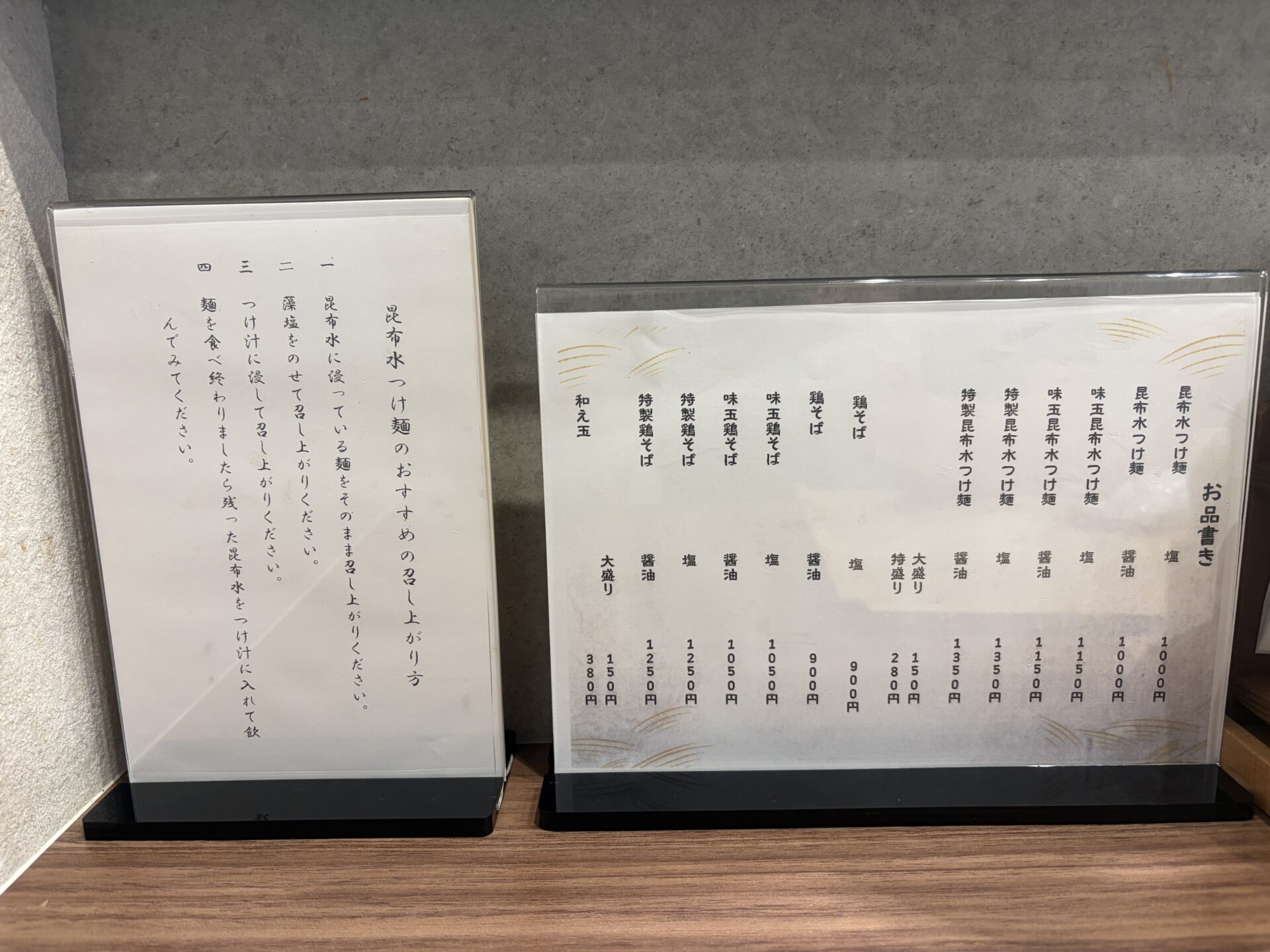 卓上のお品書きと「昆布水つけ麺のおすすめの召し上がり方」のカード